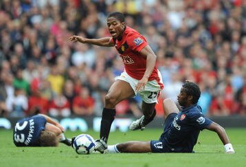 MANCHESTER, ENGLAND - AUGUST 29:  Alexandre Song of Arsenal challenges Antonio Valencia of Manchester United during the Barclays Premier League match between Manchester United and Arsenal at Old Trafford on August 29, 2009 in Manchester, England.  (Photo by Laurence Griffiths/Getty Images)