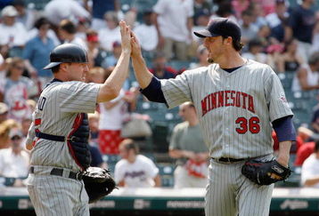 CLEVELAND - JULY 27:  Catcher Mike Redmond #55 and pitcher  Joe Nathan #38 of the Minnesota Twins celebrate after the game against the Cleveland Indians at Progressive Field on July 27, 2008 in Cleveland, Ohio.  (Photo by:  Gregory Shamus/Getty Images)