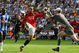 WIGAN, ENGLAND - AUGUST 22: Dimitar Berbatov of Manchester United chips the ball over Chris Kirkland of Wigan Athletic on his way to scoring the second goal during the Barclays Premier League match between Wigan Athletic and Manchester United at the DW Stadium on August 22, 2009 in Wigan, England. (Photo by Alex Livesey/Getty Images)