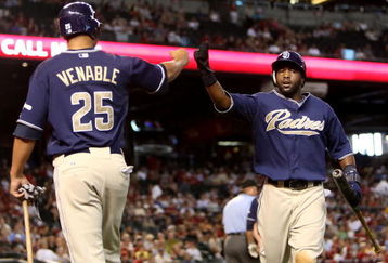 PHOENIX - JULY 08:  Tony Gwynn #18 of the San Diego Padres celebrates with teammate Will Venable #25 after Gwynn scored a run against the Arizona Diamondbacks during the fourth inning of the major league baseball game at Chase Field on July 8, 2009 in Phoenix, Arizona.  (Photo by Christian Petersen/Getty Images)