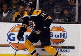 BOSTON - MAY 14:  Stephane Yelle #18 of the Boston Bruins takes the puck against the Carolina Hurricanes during Game Seven of the Eastern Conference Semifinal Round of the 2009 Stanley Cup Playoffs on May 14, 2009 at the TD Banknorth Garden in Boston, Massachusetts. The Hurricanes defeated the Bruins 3-2 in overtime.  (Photo by Elsa/Getty Images)
