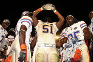 MIAMI - JANUARY 08:  Brandon Spikes #51 of the Florida Gators celebrate with the trophy after defeating the Oklahoma Sooners in the FedEx BCS National Championship Game at Dolphin Stadium on January 8, 2009 in Miami, Florida. The Gators won the game by a score of 24-14.  (Photo by Donald Miralle/Getty Images)