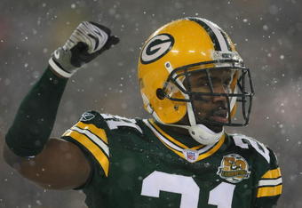 GREEN BAY, WI - JANUARY 12:  Cornerback Charles Woodson #21 of the Green Bay Packers celebrates in the final moments as the Packers defeated the Seattle Seahawks 42-20 during the NFC divisional playoff game on January 12, 2008 at Lambeau Field in Green Bay, Wisconsin.  (Photo by Jonathan Daniel/Getty Images)