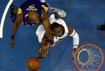 ORLANDO, FL - JUNE 09:  Dwight Howard #12 of the Orlando Magic goes up for a shot as he is fouled by Lamar Odom #7 of the Los Angeles Lakers in Game Three of the 2009 NBA Finals on June 9, 2009 at Amway Arena in Orlando, Florida.  NOTE TO USER:  User expressly acknowledges and agrees that, by downloading and or using this photograph, User is consenting to the terms and conditions of the Getty Images License Agreement.  (Photo by Elsa/Getty Images)