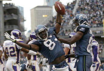 SEATTLE - AUGUST 25:  Wide receiver Nate Burleson #81 of the Seattle Seahawks celebrates an apparent touchdown with Deion Branch #83 during a preseason game against the Minnesota Vikings at Qwest Field August 25, 2007 in Seattle, Washington. Burleson was just short of the goal line on the play and the ball was spotted at the 6 inch line. (Photo by Otto Greule Jr/Getty Images)