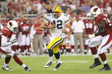 GLENDALE, AZ - AUGUST 28:  Quarterback Aaron Rodgers #12 of the Green Bay Packers rushes inbetween (L-R) Karlos Dansby #58 and Bryan Robinson #97 of the Arizona Cardinals during the first quarter at the University of Phoenix Stadium on August 28, 2009 in Glendale, Arizona.  (Photo by Christian Petersen/Getty Images)