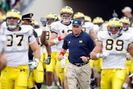 SOUTH BEND,IN - SEPTEMBER 13:  Head coach Rich Rodriguez of the Michigan Wolverines runs onto the field with his team before the game against the Notre Dame Fighting Irish on September 13, 2008 at Notre Dame Stadium in South Bend, Indiana. (Photo by: Gregory Shamus/Getty Images)