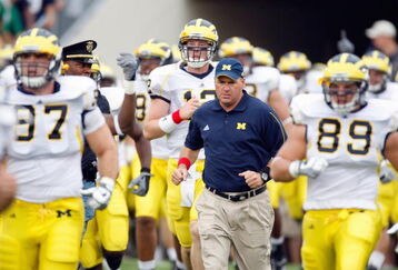 SOUTH BEND,IN - SEPTEMBER 13:  Head coach Rich Rodriguez of the Michigan Wolverines runs onto the field with his team before the game against the Notre Dame Fighting Irish on September 13, 2008 at Notre Dame Stadium in South Bend, Indiana. (Photo by: Gregory Shamus/Getty Images)