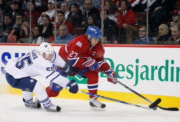 MONTREAL- JANUARY 8:  Alexei Kovalev #27 of the Montreal Canadiens stick handles the puck while being defended by Jason Blake #55 of the Toronto Maple Leafs at the Bell Centre on January 08, 2009 in Montreal, Quebec, Canada.   The Montreal Canadiens defeated the Toronto Maple Leafs 6-2.  (Photo by Richard Wolowicz/Getty Images)