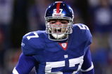 EAST RUTHERFORD, NJ - DECEMBER 29: Chase Blackburn #57 of the New York Giants celebrates after a play against the New England Patriots on December 29, 2007 at Giants Stadium in East Rutherford, New Jersey.  (Photo by Chris McGrath/Getty Images)