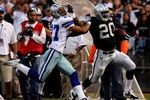 OAKLAND, CA - AUGUST 13:  Running back Darren McFadden #20 of the Oakland Raiders gives a stiff arm during a second quarter run against Courtney Brown #27 of the Dallas Cowboys during the preseason game at Oakland-Alameda County Coliseum on August 13, 2009 in Oakland, California. (Photo by Jed Jacobsohn/Getty Images)