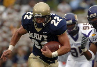 ANNAPOLIS, MD - SEPTEMBER 02:  In this handout photo Adam Ballard #22 of the Navy Midshipman is chased by Jarrett Wiggins #52 and C.J. Wilson #95 of the East Carolina Pirates in the first half of play at Navy-Marine Corps Memorial Stadium September 02, 2006 in Annapolis, Maryland.  (Photo by Damon J. Moritz/U.S. Navy via Getty Images)