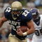 ANNAPOLIS, MD - SEPTEMBER 02:  In this handout photo Adam Ballard #22 of the Navy Midshipman is chased by Jarrett Wiggins #52 and C.J. Wilson #95 of the East Carolina Pirates in the first half of play at Navy-Marine Corps Memorial Stadium September 02, 2006 in Annapolis, Maryland.  (Photo by Damon J. Moritz/U.S. Navy via Getty Images)