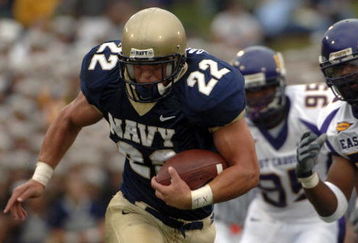 ANNAPOLIS, MD - SEPTEMBER 02:  In this handout photo Adam Ballard #22 of the Navy Midshipman is chased by Jarrett Wiggins #52 and C.J. Wilson #95 of the East Carolina Pirates in the first half of play at Navy-Marine Corps Memorial Stadium September 02, 2006 in Annapolis, Maryland.  (Photo by Damon J. Moritz/U.S. Navy via Getty Images)