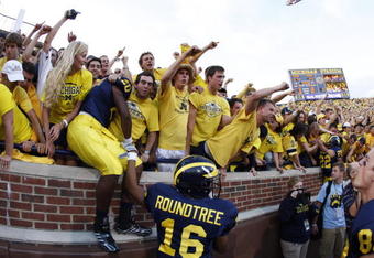 ANN ARBOR, MI - SEPTEMBER 27:  Michael Shaw #20 and Roy Roundtree #16 of the Michigan Wolverines celebrate with fans following the game against the Wisconsin Badgers on September 27, 2008 at Michigan Stadium in Ann Arbor, Michigan. (Photo by Gregory Shamus/Getty Images) 