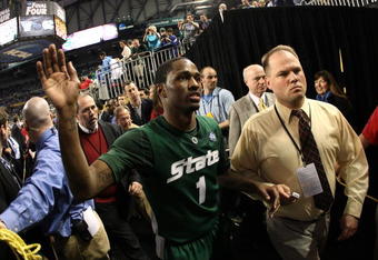 DETROIT - APRIL 04:  Kalin Lucas #1 of the Michigan State Spartans celebrates with fans as he walks off the court after their 82-73 win against the Connecticut Huskies during the National Semifinal game of the NCAA Division I Men's Basketball Championship at Ford Field on April 4, 2009 in Detroit, Michigan.  (Photo by Gregory Shamus/Getty Images)