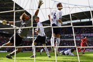 BOLTON, ENGLAND - AUGUST 29:  Steven Gerrard of Liverpool scores the winning goal past Jussi Jaaskelainen of Bolton Wanderers during the Barclays Premier League match between Bolton Wanderers and Liverpool at the Reebok Stadium on August 29, 2009 in Bolton, England.  (Photo by Alex Livesey/Getty Images)