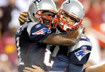LANDOVER, MD - AUGUST 28:  Tom Brady #12 and Randy Moss #81 of the New England Patriots celebrate after scoring a touchdown in the second quarter of a preseason game against the Washington Redskins at FedExField on August 28, 2009 in Landover, Maryland.  (Photo by Greg Fiume/Getty Images)