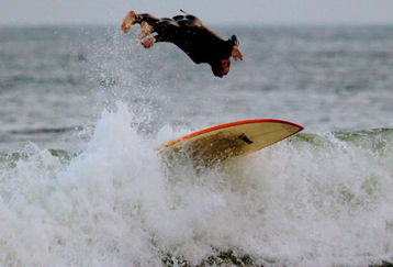 NEW YORK - AUGUST 22:  A surfer bails off his board in stong waves created by Hurricane Bill on Rockaway Beach August 22, 2009 in the Queens borough of New York City. The weakening Hurricane Bill continued northward generating high seas and closing beaches along the eastern seaboard.  (Photo by Mario Tama/Getty Images)