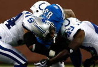 DETROIT, MI - AUGUST 28:  Wide receiver Kerry Colbert #83 of the Detroit Lions runs with the football as he is hit by several defenders against the Indianapolis Colts at Ford Field on August 28, 2009 in Detroit, Michigan. The Lions defeated the Colts 18-17.  (Photo by Scott Boehm/Getty Images)