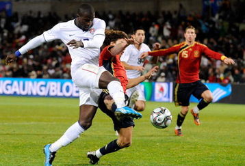 BLOEMFONTEIN, SOUTH AFRICA - JUNE 24: Jozy Altidore #17 of USA takes a shot on goal against Carles Puyol #5 of Spain during the FIFA Confederations Cup Semi Final match between Spain and USA at the Free State Stadium on June 24, 2009 in Bloemfontein, South Africa. At left is Xabi Alonso #14 od Spain.  (Photo by Kevork Djansezian/Getty Images)