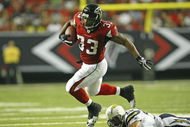 ATLANTA - AUGUST 29: Running back Michael Turner #33 of the Atlanta Falcons is tripped up by cornerback Antoine Cason #20 of the San Diego Chargers during the game at the Georgia Dome on August 29, 2009 in Atlanta, Georgia. The Falcons beat the Chargers 27-24. (Photo by Mike Zarrilli/Getty Images)
