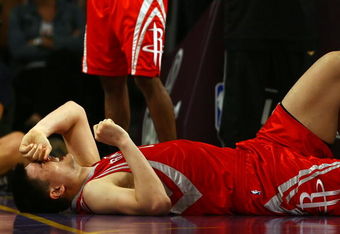 LOS ANGELES, CA - MAY 04:  Yao Ming #11 of the Houston Rockets reacts in pain after injuring his knee in the fourth quarter against the Los Angeles Lakers in Game One of the Western Conference Semifinals during the 2009 NBA Playoffs at Staples Center on May 4, 2009 in Los Angeles, California. Ming returned to the game later in the quarter. NOTE TO USER: User expressly acknowledges and agrees that, by downloading and or using this photograph, User is consenting to the terms and conditions of the Getty Images License Agreement.  (Photo by Jeff Gross/Getty Images)