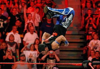 LAS VEGAS - AUGUST 24:  Wrestler Evan Bourne jumps off the ropes at wrestler Chavo Guerrero (C) as wrestler Hornswoggle lies in the foreground during the WWE Monday Night Raw show at the Thomas & Mack Center August 24, 2009 in Las Vegas, Nevada.  (Photo by Ethan Miller/Getty Images)