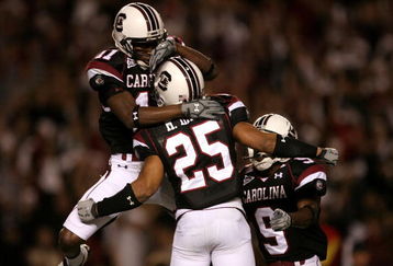 COLUMBIA, SC - NOVEMBER 01:  Teammates Moe Brown #9 and Kenny McKinley #11 celebrate with Mike Davis #25 after his touchdown against the Tennessee Volunteers # of the South Carolina Gamecocks during their game at Williams-Brice Stadium on November 1, 2008 in Columbia, South Carolina.  (Photo by Streeter Lecka/Getty Images)