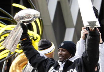 PITTSBURGH - FEBRUARY 03:  Santonio Holmes #10 of the Pittsburgh Steelers holds up his MVP and the Lombardi trophy after a parade to celebrate winning Super Bowl XLIII on February 3, 2009 in Pittsburgh, Pennsylvania.  (Photo by Gregory Shamus/Getty Images)