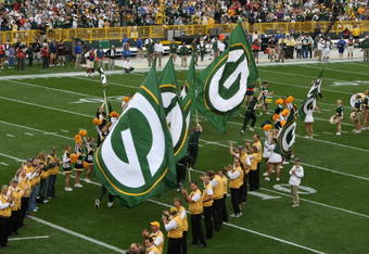 GREEN BAY, WI - SEPTEMBER 09: Cheerleaders carry flags of the Green Bay Packers as they run onto the field before a game against the Philadelphia Eagles on September 9, 2007 at Lambeau Field in Green Bay, Wisconsin. The Packers defeated the Eagles 16-13. (Photo by Jonathan Daniel/Getty Images)