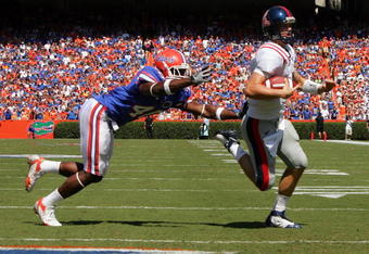 GAINESVILLE, FL - SEPTEMBER 27:  Quarterback Jevan Snead #4 of the Ole Miss Rebels runs for a touchdown against Brnadon Hicks #40 of the Florida Gators during the game at Ben Hill Griffin Stadium on September 27, 2008 in Gainesville, Florida.  (Photo by Sam Greenwood/Getty Images)