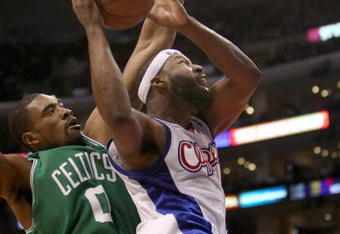 LOS ANGELES - FEBRUARY 25:  Baron Davis #1 of the Los Angeles Clippers goes in for a shot over Leon Powe #0 of the Boston Celtics on February 25, 2009 at Staples Center in Los Angeles, California.  The Clippers won 93-91.   NOTE TO USER: User expressly acknowledges and agrees that, by downloading and/or using this Photograph, user is consenting to the terms and conditions of the Getty Images License Agreement. (Photo by Stephen Dunn/Getty Images)