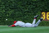 CHICAGO - JULY 26: Chris Dickerson #21 of the Cincinnati Reds hits the ground trying to make a catch in the 8th inning against the Chicago Cubs on July 26, 2009 at Wrigley Field in Chicago, Illinois. The Cubs defeated the Reds 5-2.  (Photo by Jonathan Daniel/Getty Images)