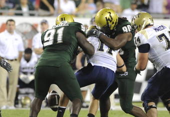 TAMPA, FL - OCTOBER 2:  Quarterback Bill Stull #11 of the Pittsburgh Panthers fumbles under pressure from the defense of the University of South Florida Bulls at Raymond James Stadium on October 2, 2008 in Tampa, Florida.  (Photo by Al Messerschmidt/Getty Images)
