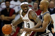 CLEVELAND - JUNE 12:  LeBron James #23 of the Cleveland Cavaliers posts up against Bruce Bowen #12 of the San Antonio Spurs in Game Three of the NBA Finals on June 12, 2007 at the Quicken Loans Arena in Cleveland, Ohio. NOTE TO USER: User expressly acknowledges and agrees that, by downloading and or using this photograph, User is consenting to the terms and conditions of the Getty Images License Agreement.  (Photo by Gregory Shamus/Getty Images)