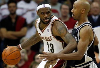 CLEVELAND - JUNE 12:  LeBron James #23 of the Cleveland Cavaliers posts up against Bruce Bowen #12 of the San Antonio Spurs in Game Three of the NBA Finals on June 12, 2007 at the Quicken Loans Arena in Cleveland, Ohio. NOTE TO USER: User expressly acknowledges and agrees that, by downloading and or using this photograph, User is consenting to the terms and conditions of the Getty Images License Agreement.  (Photo by Gregory Shamus/Getty Images)