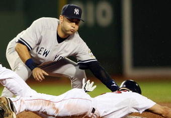 BOSTON - AUGUST 23:  Derek Jeter #2 of the New York Yankees tags out Jacoby Ellsbury #46 of the Boston Red Sox as he is trying to steal second on August 23, 2009 at Fenway Park in Boston, Massachusetts.  (Photo by Elsa/Getty Images)