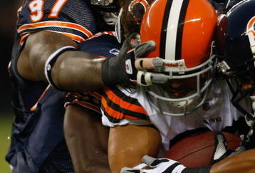 CHICAGO, IL - SEPTEMBER 3: Running back Noah Herron #33 of the Cleveland Browns is tackled by several defenders against the Chicago Bears at Soldier Field on September 3, 2009 in Chicago, Illinois. (Photo by Scott Boehm/Getty Images)