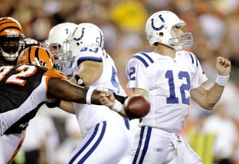 CINCINNATI, OH - AUGUST 3:   Frostee Rucker #92 of the Cincinnati Bengals strips the ball from Jim Sorgi #12 of the Indianapolis Colts during the preseason game on August 3, 2009 at Paul Brown Stadium in Cincinnati, Ohio.  (Photo by Andy Lyons/Getty Images)