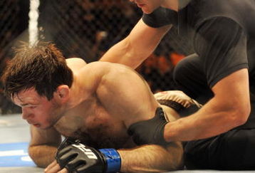 PHILADELPHIA - AUGUST 08:  (Bottom) Forrest Griffin on the ground after being defeated by Anderson Silva during their light heavyweight bout at UFC 101: Declaration at the Wachovia Center on August 8, 2009 in Philadelphia, Pennsylvania.  (Photo by Jon Kopaloff/Getty Images)