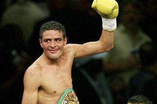 LAS VEGAS - JULY 16:  Oscar Larios celebrates his victory against Wayne McCullough after their super bantamweight championship fight at the MGM Grand Garden Arena on July 16, 2005 in Las Vegas, Nevada. Larios won the fight by TKO in the 10th round.  (Photo by Ethan Miller/Getty Images)
