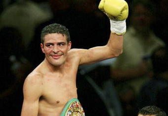LAS VEGAS - JULY 16:  Oscar Larios celebrates his victory against Wayne McCullough after their super bantamweight championship fight at the MGM Grand Garden Arena on July 16, 2005 in Las Vegas, Nevada. Larios won the fight by TKO in the 10th round.  (Photo by Ethan Miller/Getty Images)