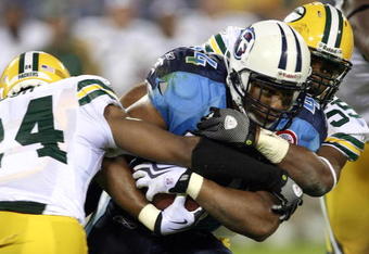 NASHVILLE, TN - SEPTEMBER 3: Rodney Ferguson #44 of the Tennessee Titans is tackled by Jarrett Bush #24 and Desmond Bishop #55 of the Green Bay Packers during a preseason NFL game at LP Field on September 3, 2009 in Nashville, Tennessee. The Titans beat the Packers 27-13. (Photo by Joe Murphy/Getty Images)
