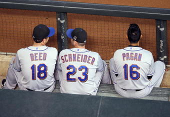 PHOENIX - AUGUST 12:  (L-R) Jeremy Reed #18, Brian Schneider #23 and Angel Pagan #16 of the New York Mets look on from the dugout during the major league baseball game against the Arizona Diamondbacks at Chase Field on August 12, 2009 in Phoenix, Arizona. The Mets defeated the Diamondbacks 6-4.  (Photo by Christian Petersen/Getty Images)