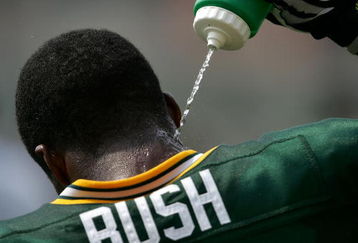 GREEN BAY, WI - AUGUST 6:  Jarrett Bush #24 of the Green Bay Packers squirts water on his neck during summer training camp practice on August 6, 2007 at the Hutson Center in Green Bay, Wisconsin.  (Photo by Jonathan Daniel/Getty Images)