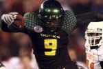 SAN DIEGO, CA - DECEMBER 30:   Runningback LeGarrette Blount #9 of the University of Oregon Ducks hurdles a player en route to a touchdown during his team's 42-31 win over the Oklahoma State University Cowboys in the Pacific Life Holiday Bowl at Qualcomm Stadium on December 30, 2008 in San Diego, California. (Photo by Donald Miralle/Getty Images)