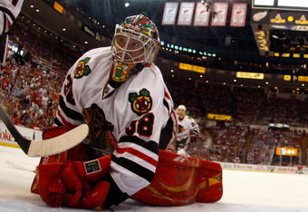DETROIT - MAY 27:  Cristobal Huet #38 of the Chicago Blackhawks looks back behind the net against the Detroit Red Wings during Game Five of the Western Conference Championship Round of the 2009 Stanley Cup Playoffs on May 27, 2009 at Joe Louis Arena in Detroit, Michigan.  (Photo by Gregory Shamus/Getty Images)