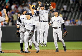 BALTIMORE - SEPTEMBER 01:  Derek Jeter #2 and Nick Swisher #33 of the New York Yankees celebrate with teammates after a 9-6 victory against the Baltimore Orioles at Camden Yards on September 1, 2009 in Baltimore, Maryland.  (Photo by Greg Fiume/Getty Images)