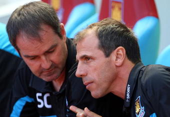 LONDON, ENGLAND - AUGUST 23:  Gianfranco Zola Manager of West Ham United holds a golf ball whilst talking with Steve Clarke during the Barclays Premier League match between West Ham United and Tottenham Hotspur at Upton Park on August 23, 2009 in London, England.  (Photo by Phil Cole/Getty Images)
